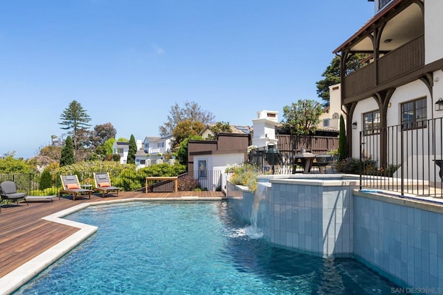 view of swimming pool featuring a deck