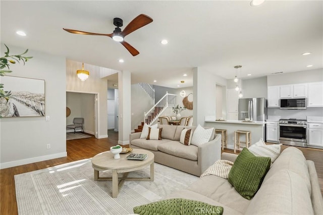 living room featuring ceiling fan and light hardwood / wood-style flooring