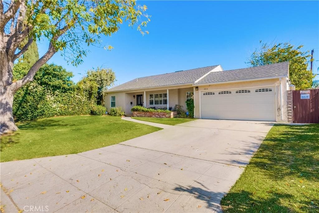 single story home with a garage and a front yard