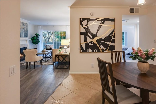 dining room with crown molding and tile patterned flooring