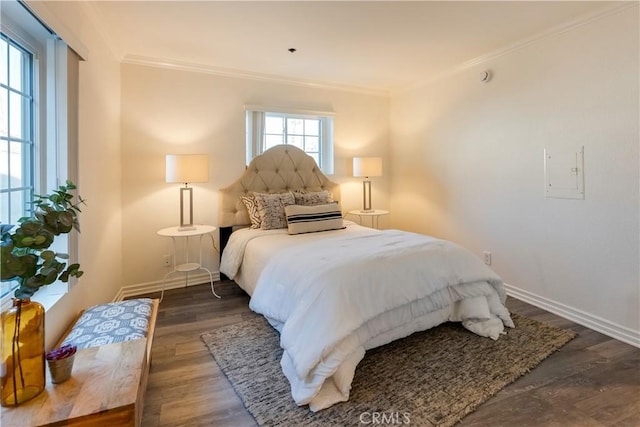 bedroom with dark hardwood / wood-style floors and ornamental molding