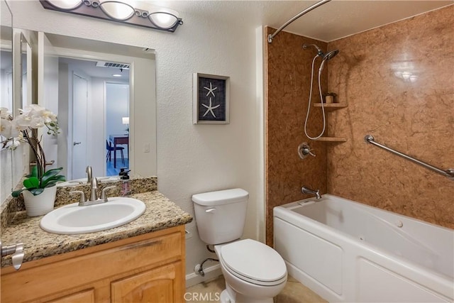 full bathroom featuring tiled shower / bath combo, toilet, and vanity