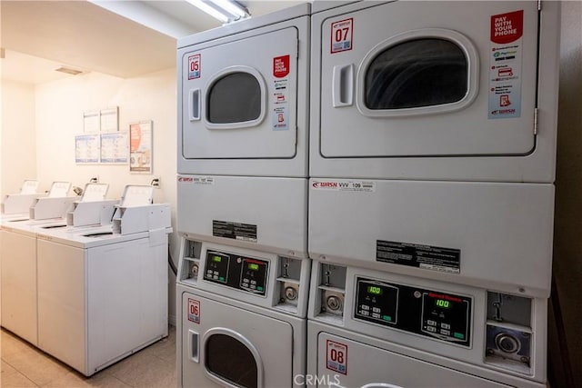 washroom featuring washing machine and dryer and stacked washing maching and dryer