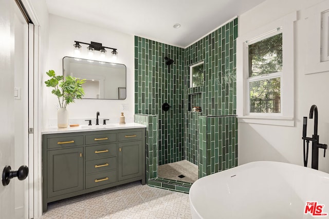 bathroom with tile patterned floors, vanity, and independent shower and bath