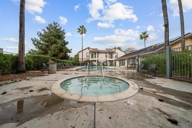 view of pool with a patio area and a hot tub