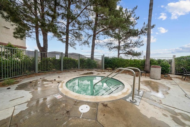 view of pool featuring a community hot tub and a patio area