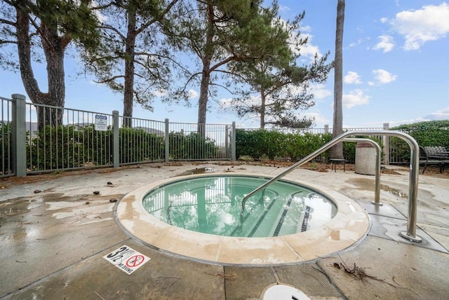 view of pool with a hot tub and a patio