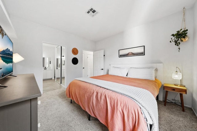 carpeted bedroom featuring connected bathroom