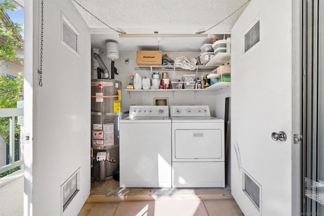 laundry area featuring washer and dryer and strapped water heater