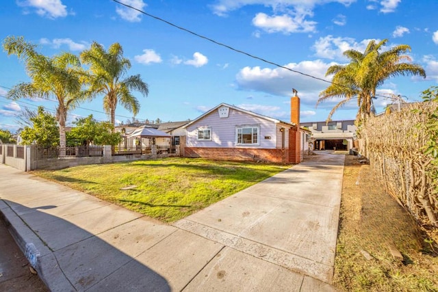 view of front of house with a carport and a front lawn