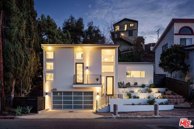 modern home with a garage and a balcony