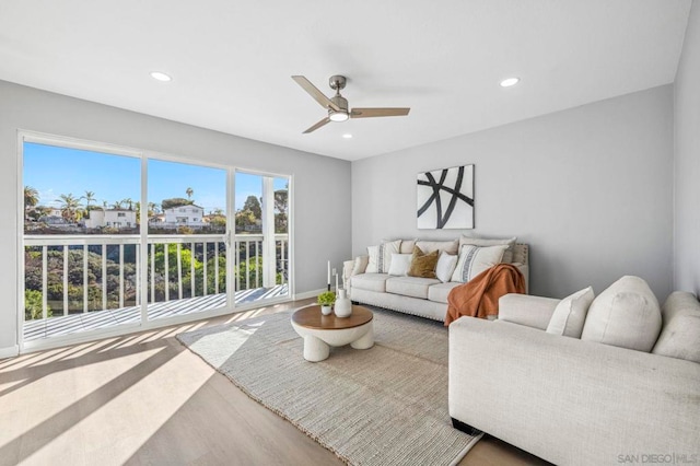 living room with ceiling fan and wood-type flooring