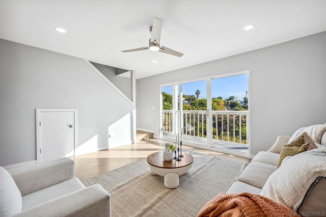 living room with light wood-type flooring and ceiling fan