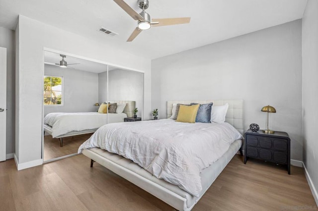 bedroom with light wood-type flooring, a closet, and ceiling fan