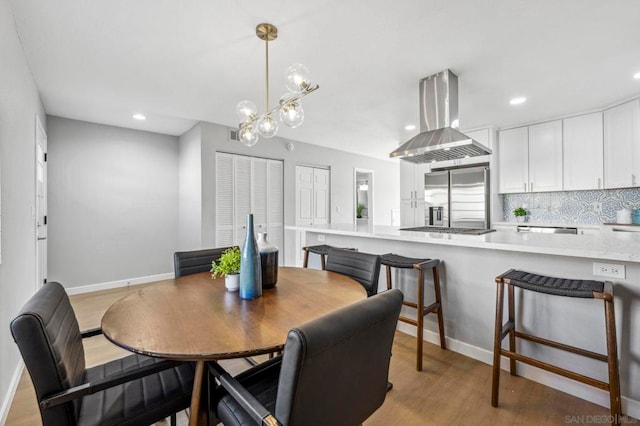 dining room featuring an inviting chandelier and light wood-type flooring