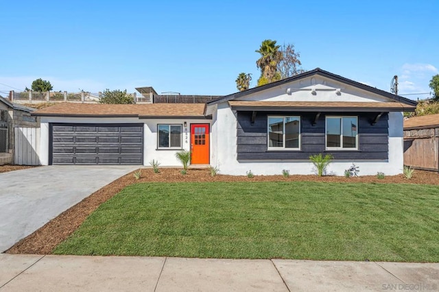 ranch-style home featuring a garage and a front lawn