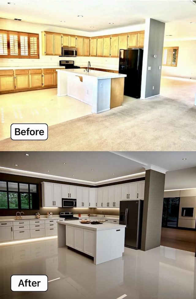 kitchen with a kitchen island, appliances with stainless steel finishes, sink, and white cabinets