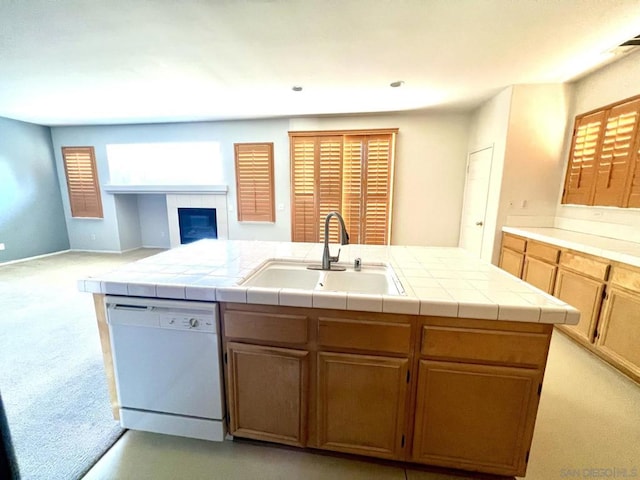 kitchen featuring light colored carpet, tile countertops, dishwasher, and sink