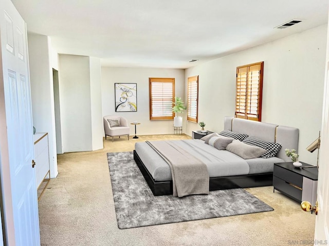 bedroom with light colored carpet