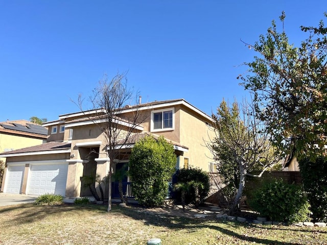 view of front of property with a garage and a front yard