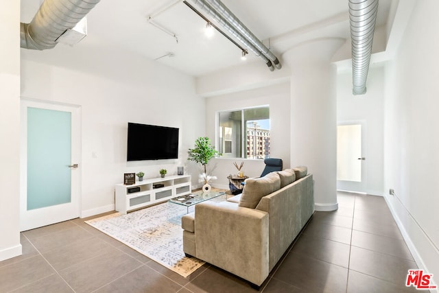 tiled living room featuring rail lighting