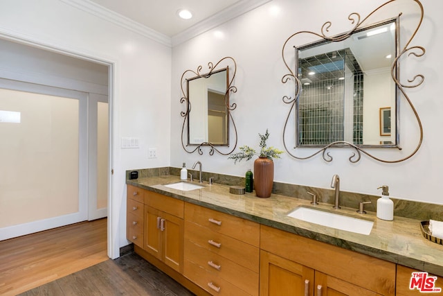 bathroom featuring vanity, hardwood / wood-style flooring, and ornamental molding