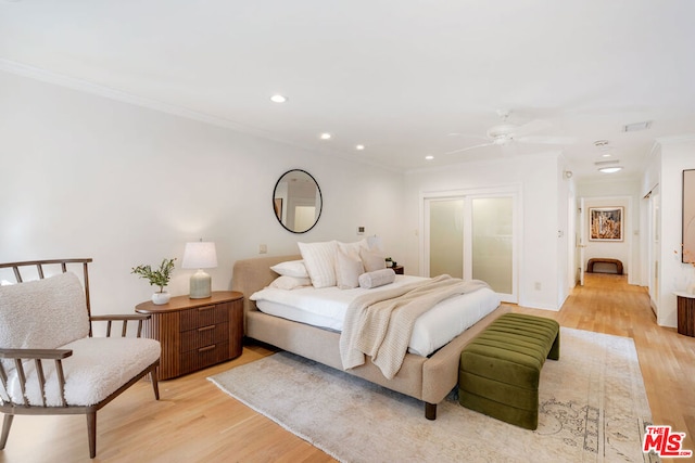 bedroom with ceiling fan, ornamental molding, and light hardwood / wood-style floors