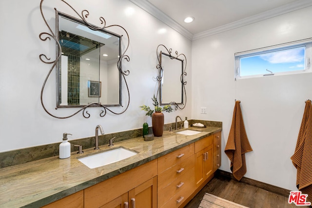 bathroom featuring crown molding, hardwood / wood-style floors, and vanity