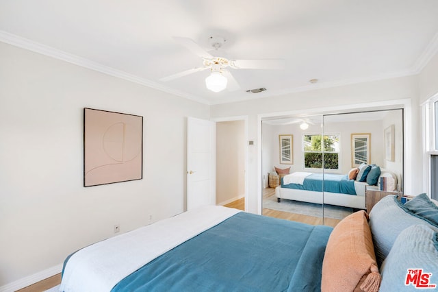 bedroom with a closet, ceiling fan, light hardwood / wood-style flooring, and crown molding