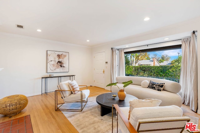 living room featuring wood-type flooring and ornamental molding