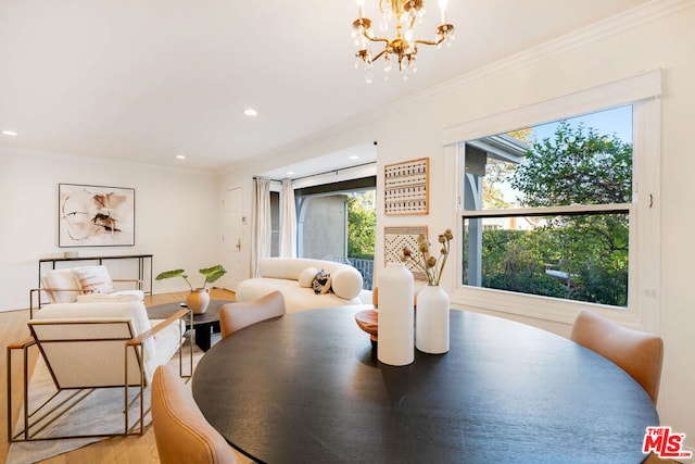 dining room with crown molding and an inviting chandelier