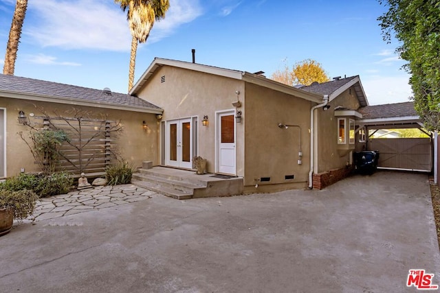 rear view of property featuring a patio and french doors