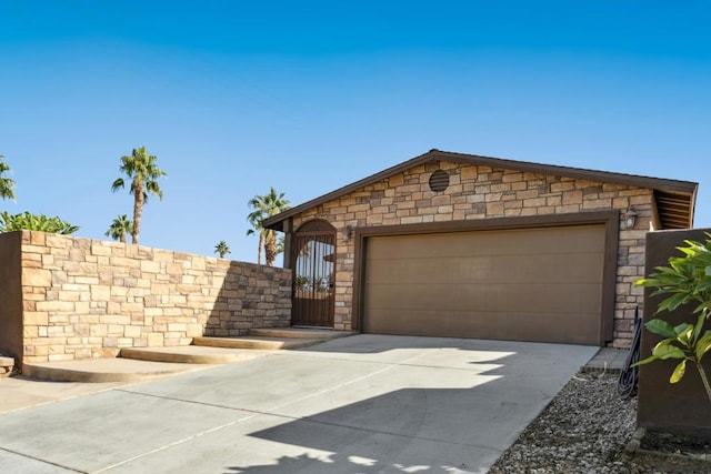 ranch-style house featuring a garage and an outbuilding