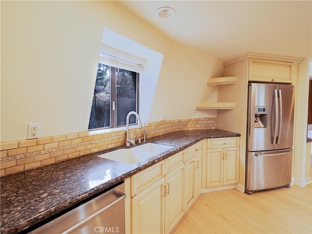 kitchen with tasteful backsplash, stainless steel appliances, sink, and dark stone counters