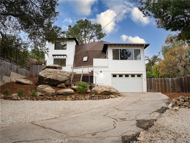 view of front of property with a garage and a deck