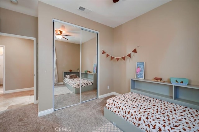 carpeted bedroom with a closet and ceiling fan