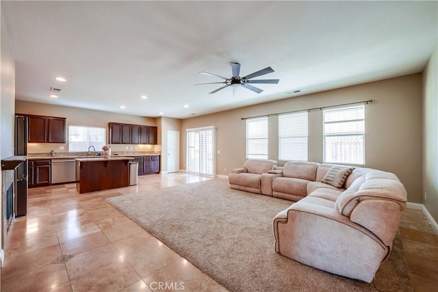 tiled living room with sink and ceiling fan