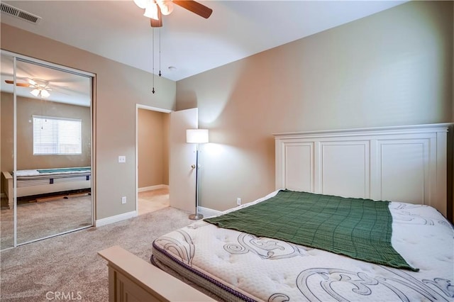 bedroom with light carpet, a closet, vaulted ceiling, and ceiling fan