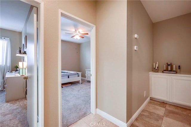 bathroom with ceiling fan and tile patterned flooring