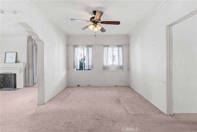 unfurnished room with ceiling fan and light colored carpet