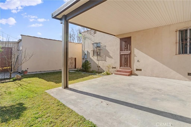 exterior space featuring a patio area and a lawn