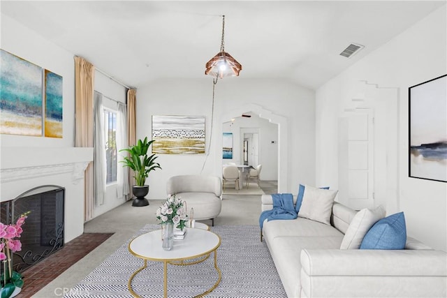 carpeted living room featuring vaulted ceiling