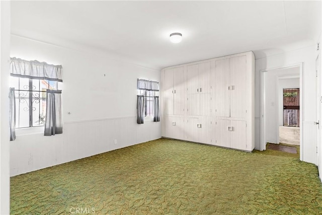 unfurnished bedroom featuring carpet and a closet