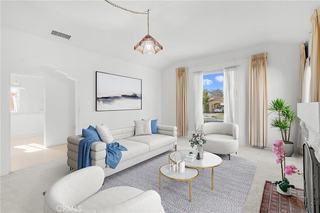 living room with vaulted ceiling and light carpet