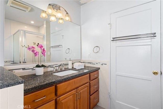 bathroom with an enclosed shower and vanity