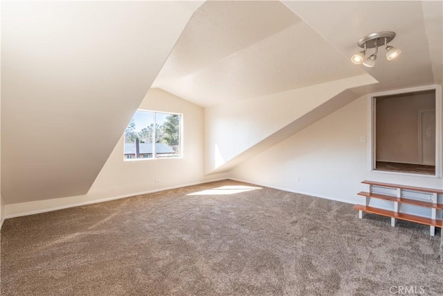 additional living space featuring vaulted ceiling and carpet floors