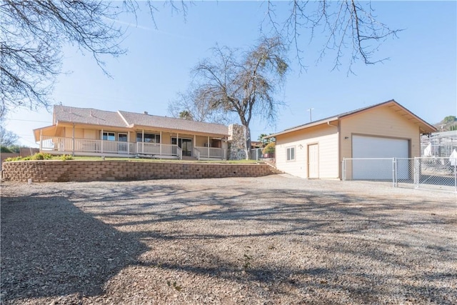 ranch-style house featuring a garage and covered porch