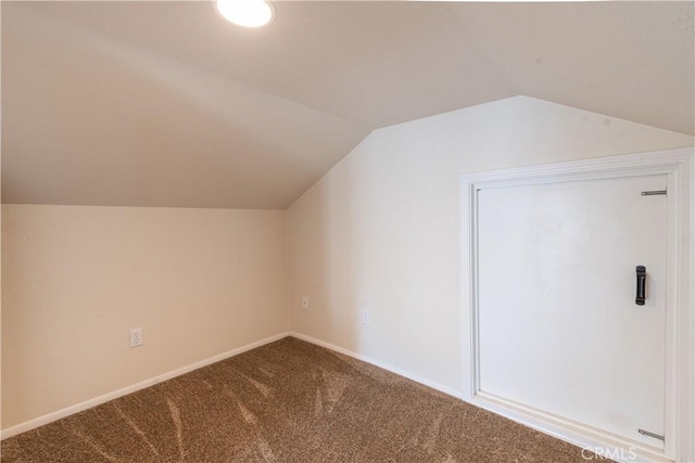 bonus room with carpet floors and vaulted ceiling