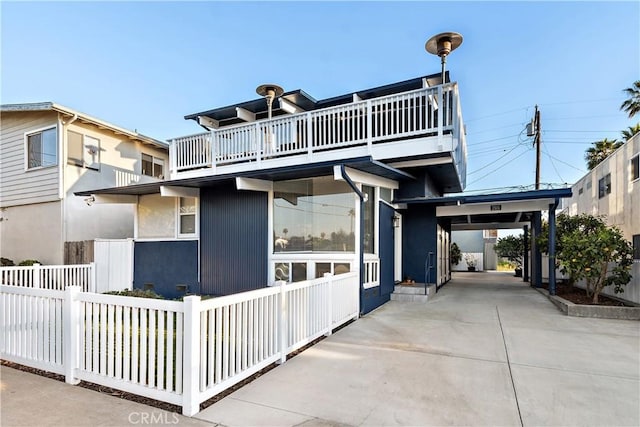 view of front of house featuring a balcony