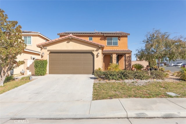 mediterranean / spanish-style house with a garage